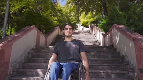 Disabled-young-man-has-difficulty-walking-in-his-wheelchair-on-the-street.